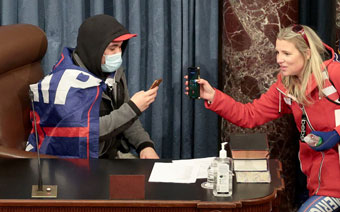 masked man takes selfie during riot at U.S. Capitol