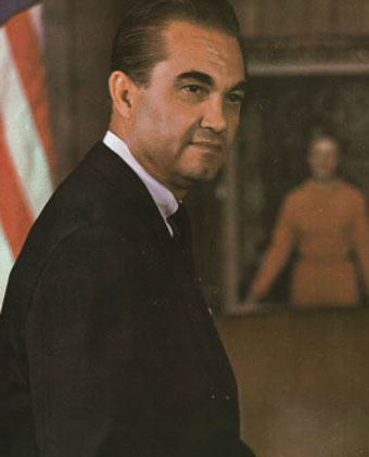 George Wallace next to American flag