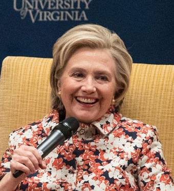 Hillary Clinton sitting with microphone