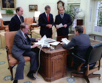 Ronald Reagan meeting with staff in Oval Office