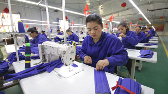 Uigur women work in a cloth factory in Hotan county, Xinjiang province, China.