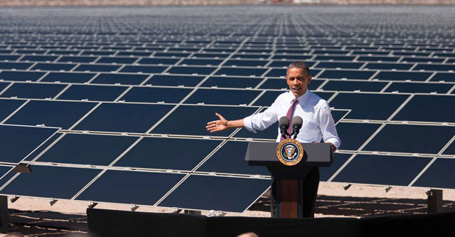 President Obama in front of solar panels