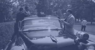 Secret service members gathered around a car