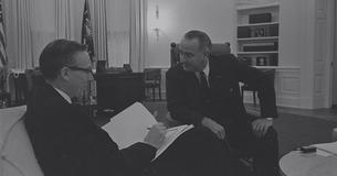 LBJ sitting and talking to Walter Heller