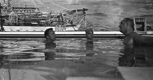 LBJ talks to advisers in the White House pool