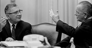 Wilbur Mills and LBJ talking at a table