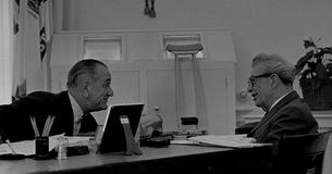 LBJ leans toward Everett Dirksen while they talk