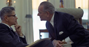 LBJ leaning in to talk to Secretary of Agriculture Orville L. Freeman