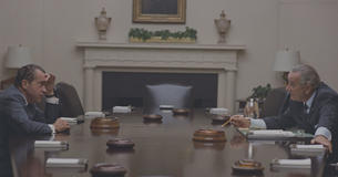 Nixon and LBJ talking to each other across a table