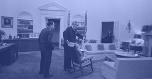 LBJ pointing to something in the Oval Office with Richard Nixon