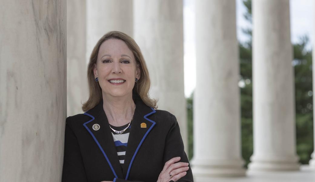 Barbara Perry standing among UVA columns