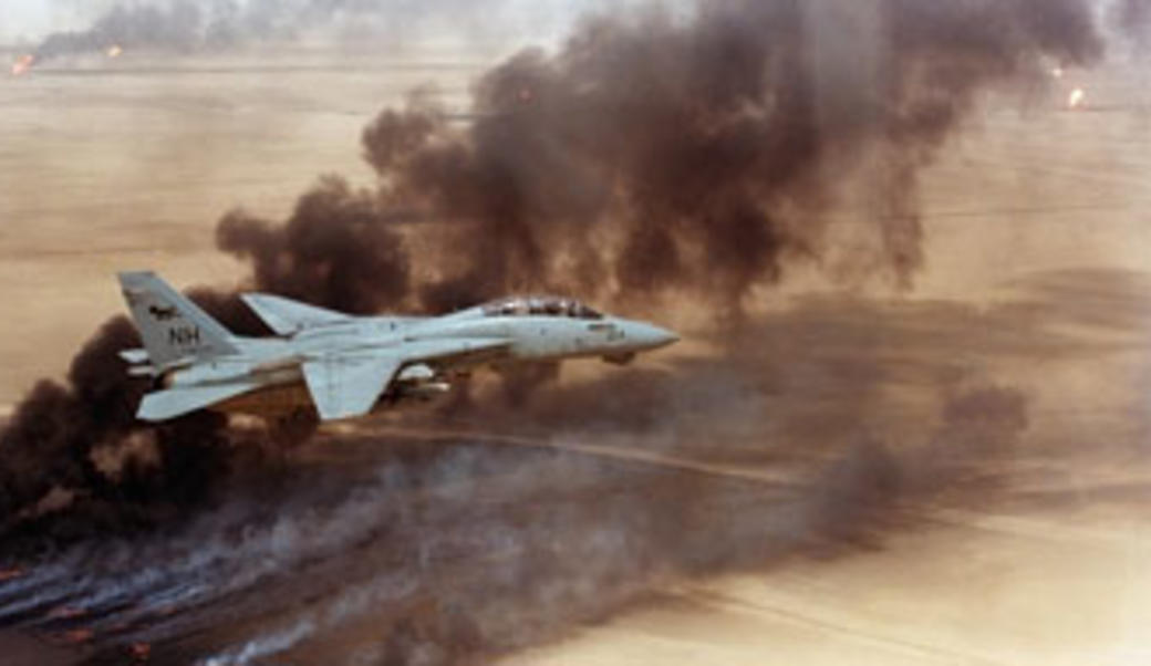 F-14 fighter in flight over burning Kuwaiti oil wells set on fire in March by retreating Iraqi forces were still burning on Aug. 1 1991.