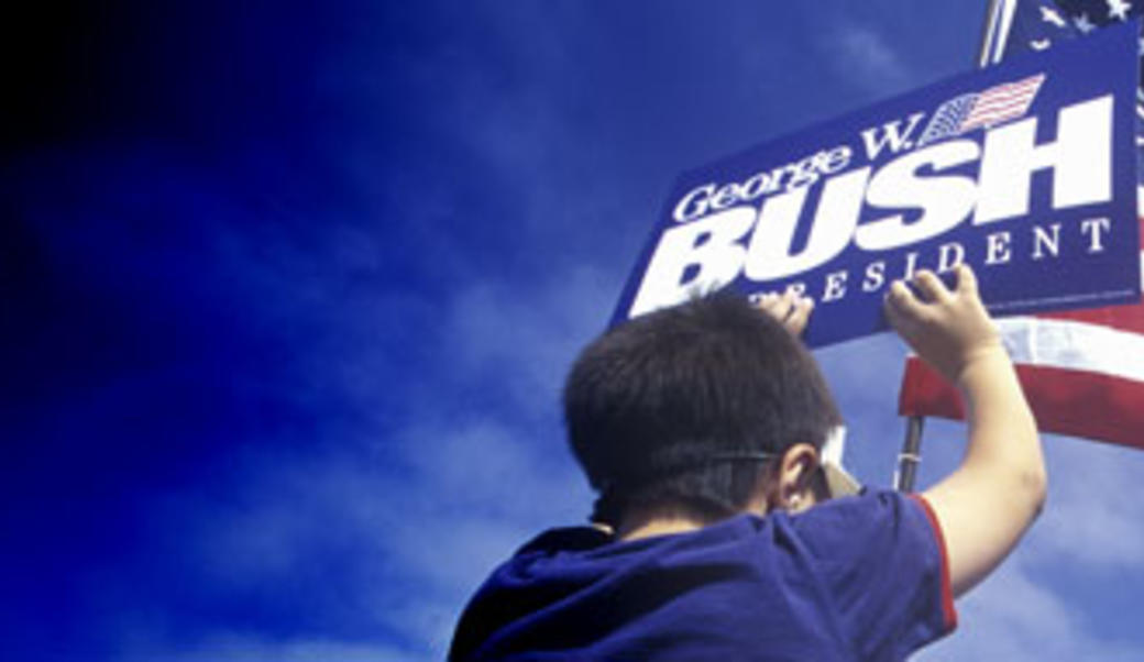 Man holding Bush Cheney sign