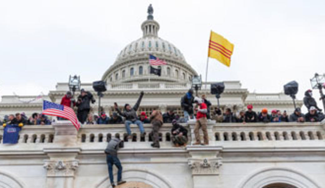 People climbing up U.S. Capitol