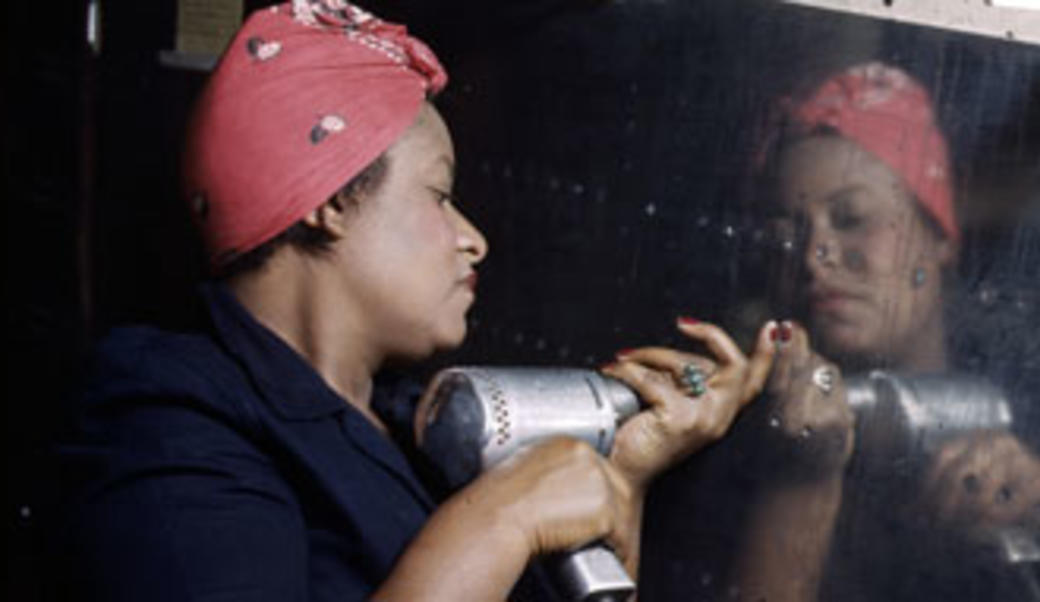 Woman adding rivets to a plane