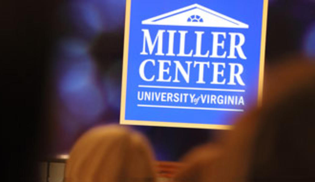 MILLER Center logo in front of audience at in-person event