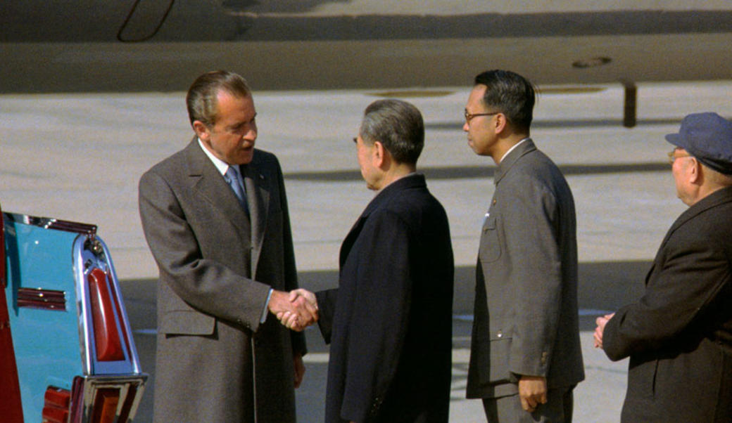 Nixon and premier choi en lai shake hands in peking china