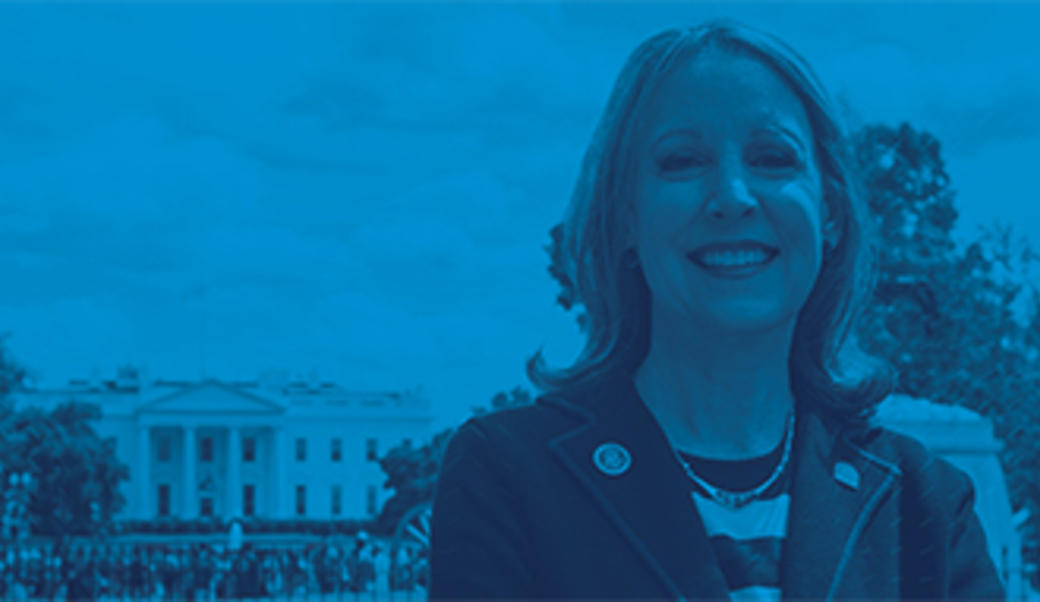headshot of Barbara Perry in front of the White House