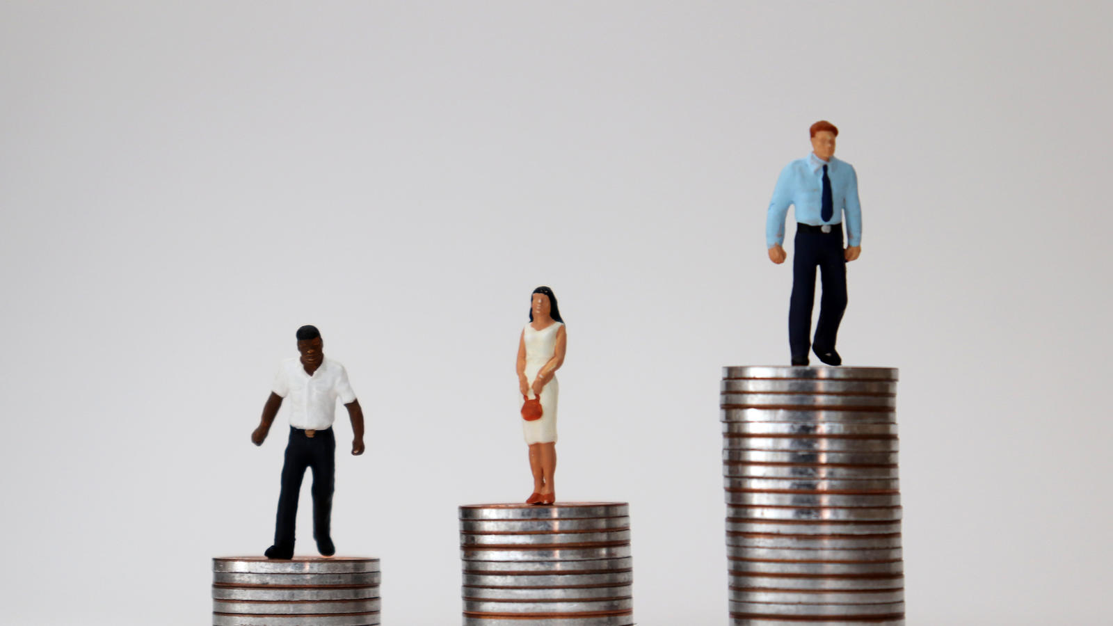 people dolls on stacks of coin